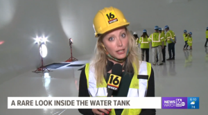 image of reporter discussing a very clean water tank treated by Blue Earth Products The Science of Safe Water