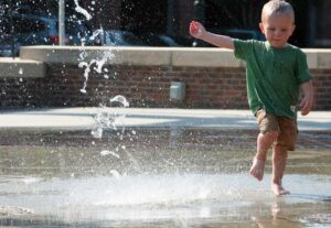 young boy playing in water at city park Blue Earth Products The Science of Safe Water